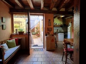 a living room with a door open to a kitchen at Casa Rural Mi Rinconcillo in Valleruela de Pedraza