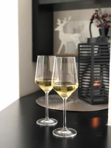 two glasses of white wine sitting on a table at Danijela & konak in Zlatibor