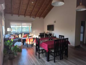 a living room with a table and chairs and a couch at Old Willow in Chacras de Coria