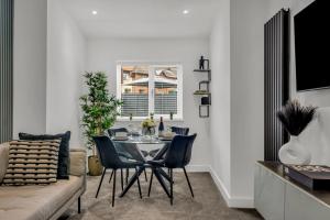 a dining room with a table and chairs and a couch at Stanley Park House Peterborough - 3 bed, 3 bathroom, parking, garden in Peterborough +58 photos