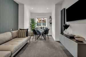 a living room with a couch and a table at Stanley Park House Peterborough - 3 bed, 3 bathroom, parking, garden in Peterborough