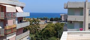 a view of the ocean from between two buildings at La casa di mest Pepp in Monopoli