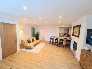a living room with a yellow couch and a table at Luxury, Spacious 3 Bedroom, Beachfront Apt with Parking & Courtyard - Shoreside in Margate