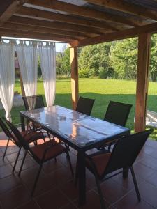 a table and chairs on a screened in porch at Vacation home Zara in Lohovo