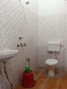 a bathroom with a toilet and a sink at Virat Palace in Deoghar