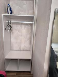 a closet with a white cabinet in a room at Welcome home F2 in Stains