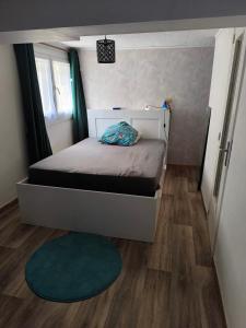 a small bedroom with a bed and a green rug at Welcome home F2 in Stains +10 photos