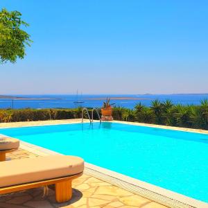 a swimming pool with a view of the ocean at Paros Afrodite Luxury Villas in Aliki