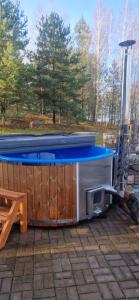 a hot tub sitting on a patio next to a table at Namas su pirtimi Trakai in Salkininkai