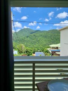 a window with a view of a mountain at Studio DREAM avec petit déjeuner in Pointe-Noire