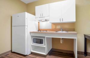 a kitchen with a sink and a white refrigerator at Extended Stay America Suites - Mobile - Spring Hill in Mobile
