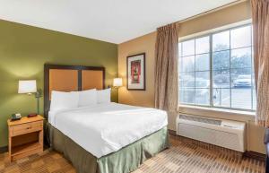 a bedroom with a bed and a large window at Extended Stay America Select Suites - Chicago - Westmont - Oak Brook in Westmont +48 photos