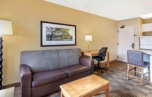 a living room with a couch and a desk at Extended Stay America Select Suites - Chicago - Westmont - Oak Brook in Westmont