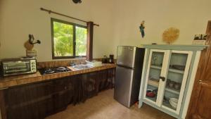 a kitchen with a stainless steel refrigerator and a window at Villasjungle 2 in Sámara