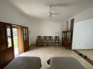 a living room with a bed and chairs in it at CÉNTRICO in Santiago del Estero