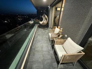a balcony with chairs and a view of the city at Seaview Smart Home 2 in Varna City