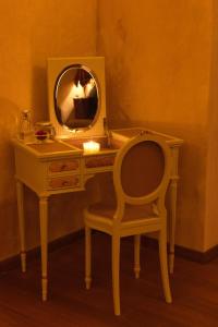 a dressing table with a chair and a mirror at Imaret in Kavála