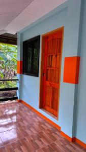 an empty room with a red door in a house at Lucia Guesthouse in San Juan