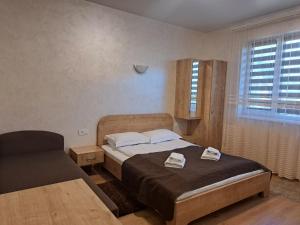 a bedroom with a bed and a chair in it at Solomiia in Solochyn +39 photos