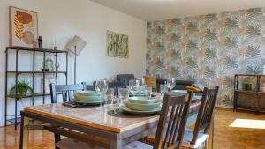 Un comedor con una mesa con platos y copas de vino. en No3 by 21 Apartments, en Krefeld
