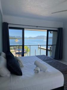 a bedroom with a bed with a view of the ocean at Lucinda Cove Resort in Lucinda