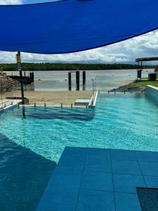 a large pool of blue water next to a beach at Lucinda Cove Resort in Lucinda +17 photos