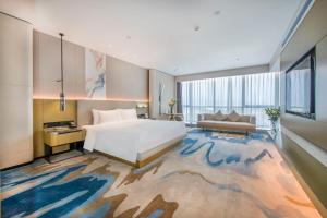 Postel nebo postele na pokoji v ubytování Eastern Casa Hotel Yiwu + 26 fotografií