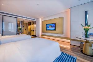 Postelja oz. postelje v sobi nastanitve Eastern Casa Hotel Yiwu