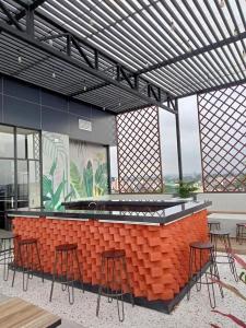 a bar in a building with stools around it at Wisma Davinci PematangSiantar in Pematangsiantar +8 photos