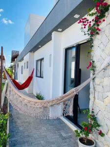a house with a hammock in front of it at LD House- Bananeiras in Bananeiras