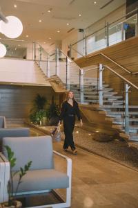 a woman walking down a hallway in a building at Holiday Inn Express - Cartagena Bocagrande by IHG in Cartagena de Indias +137 photos