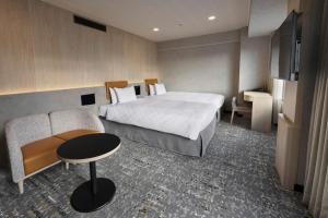 a hotel room with a bed and a table and a couch at Shinjuku Prince Hotel in Tokyo +37 photos