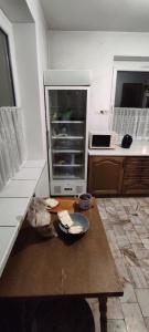 a kitchen with a table in the middle of it at Adam room 7 in Wrocław