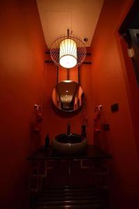 a bathroom with a sink and a mirror at Caiyong Hometel & Cafe's Studio in Khlong San