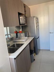 Una cocina o zona de cocina en Cómodo depto concón