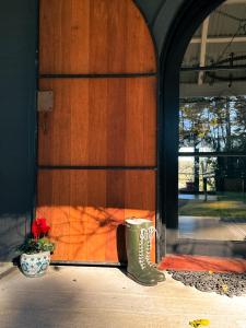 a door with a potted plant in front of it at The Grange Berrima - The Ultimate Rural Retreat in Berrima