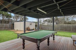 a pool table on a deck in a backyard at Island Surf & Sun in Surf Beach