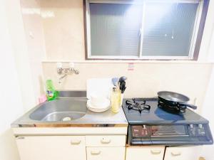 Una cocina o kitchenette en 西武新宿線 駅近最大4人d2