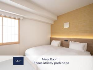 Postel nebo postele na pokoji v ubytování MIMARU Osaka Shinsaibashi North