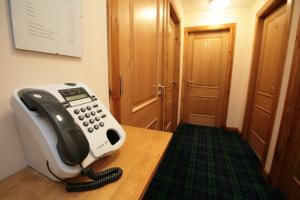 a telephone sitting on a desk in a room at The Ship Inn in Stonehaven