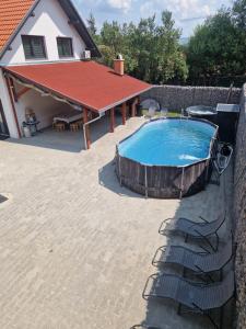 a swimming pool in front of a house at Fancsali Lak in Ulcani