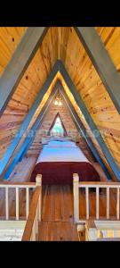 een slaapkamer op een houten zolder met een bed bij Sarp Bungalov in Kemalpasa +18 foto's