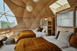赤穗Dot Glamping 赤穂的带有金字塔天花板的房间里有两张床