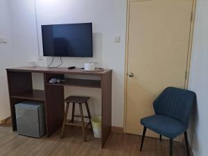 a desk with a television and a chair in a room at Studio Hotel Style Saville Cheras link MRT Sri Raya in Cheras