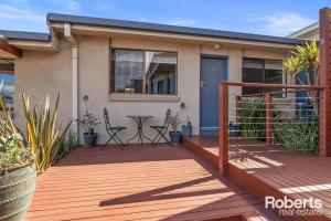 a house with a wooden deck with chairs and plants at Heavenly Hawley in Hawley Beach