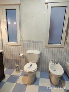 a bathroom with a toilet and a sink at Apartamento A Coruña in Oleiros +26 photos