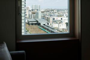 a view of a city from a window at The Mark Grand Hotel in Saitama