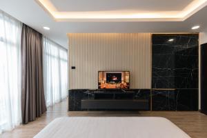 a bedroom with a large black marble wall at Luxhome Mekong Hotel in Can Tho