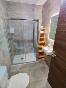 a bathroom with a shower and a toilet and a sink at Diamond Residence Qawra - Side Sea View in St Paul's Bay