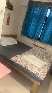 a room with two beds and a blue curtain at cebu hostel in Hong Kong